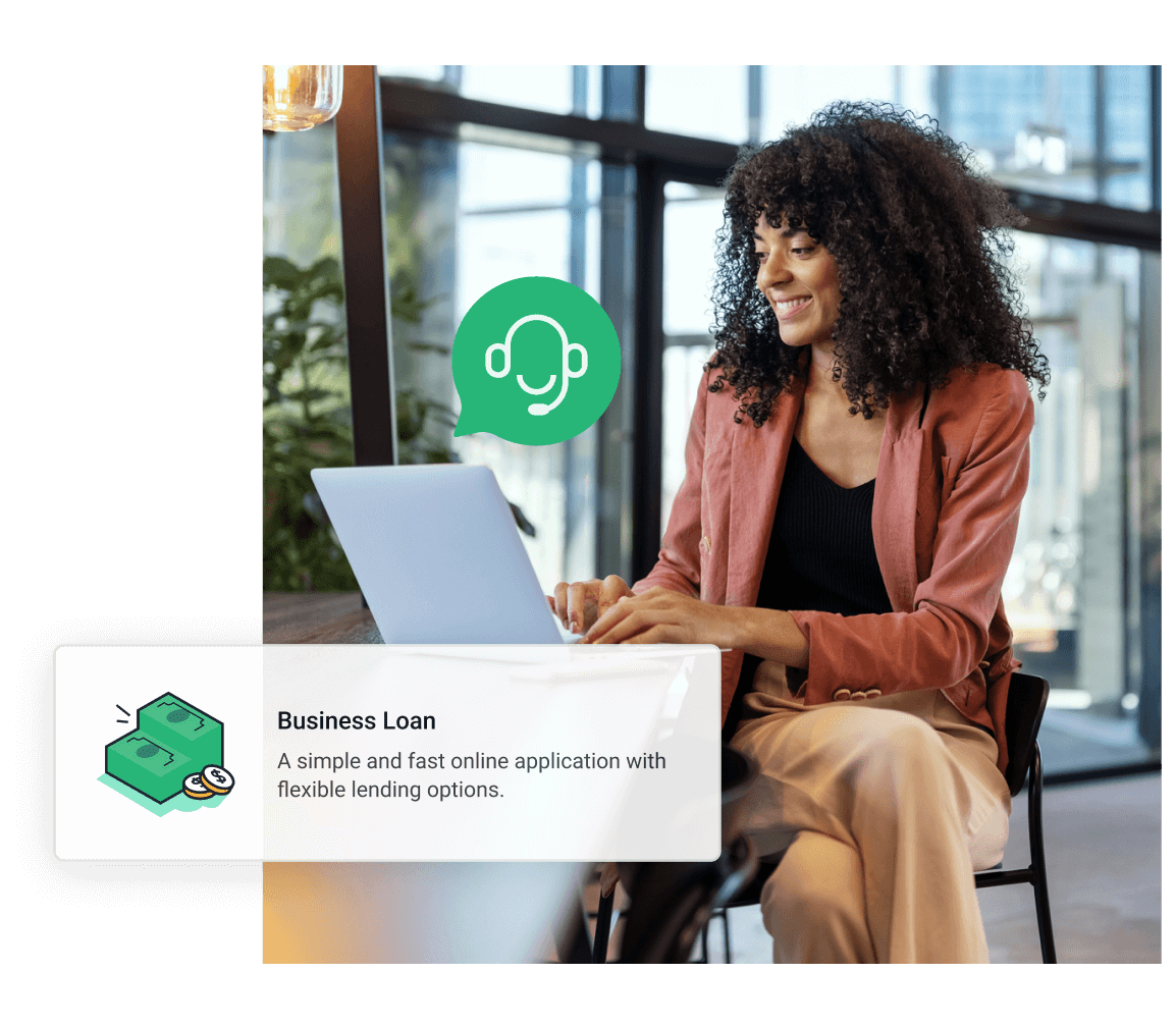 Young woman sitting at a table working on a laptop wearing a blazer. Business loan, a simple and fast online application with flexible lending options.